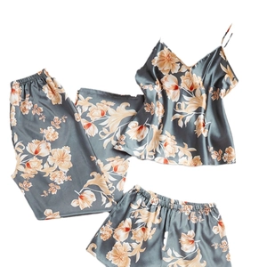 Three-piece satin pajama set with floral print including camisole, pants, and shorts