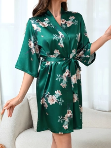 Detail of dark green satin floral robe with butterfly prints and elegant kimono V-neckline