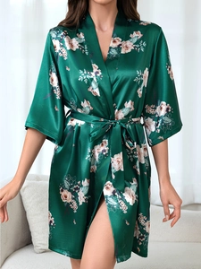 Detailed view of green floral satin robe featuring smooth texture and elegant waist tie belt