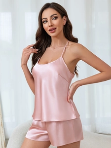 Detail of silk-like satin sleepwear set with camisole and shorts in elegant champagne pink
