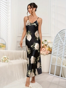Close-up of black satin slip nightdress with large floral print and silky texture