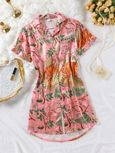 Flat lay of pink satin sleepshirt with jungle tiger and floral print and silk texture