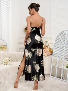Detail of black floral satin slip dress featuring cross back straps and side slit