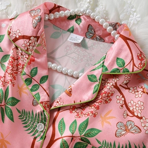 Pink satin pajama shirt with jungle butterfly print and green piping details