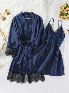 Detail of navy blue silk pajama set featuring delicate black eyelash lace trim and satin texture