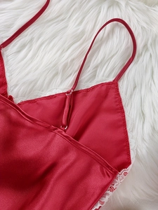 Close-up of red silk satin nightgown featuring delicate white lace trim and straps