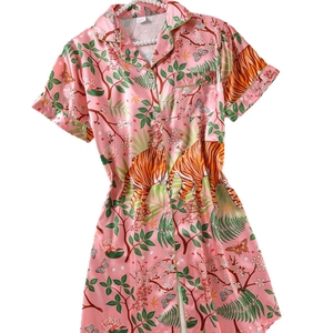 Pink satin short sleeve pajama dress featuring jungle tiger print and green piping trim