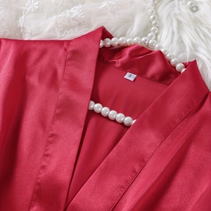 Elegant red satin robe and nightgown set with silky finish and luxury accessories