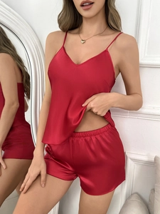 Detail of red satin pajamas showing the v-neck camisole and elastic waistband shorts