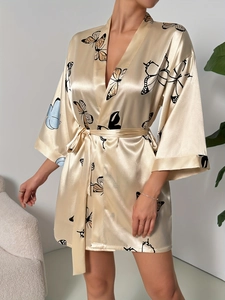 Detail of champagne satin robe featuring elegant black and light blue butterfly print patterns