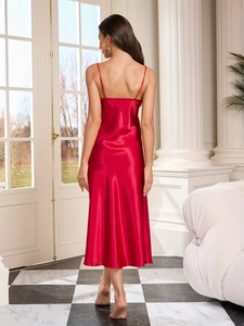 Detail of elegant red satin long nightgown showing back cut and silky texture