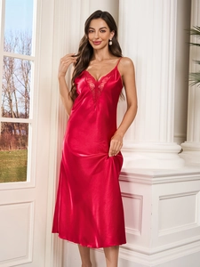 Detail of red satin nightgown with elegant lace V-neck and smooth silk texture