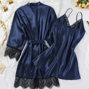 Navy blue satin pajama set with lace trim including a robe and slip dress on white fabric