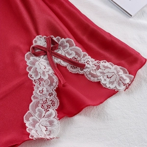 Red satin slip dress with delicate white floral lace trim and a matching silk bow accent