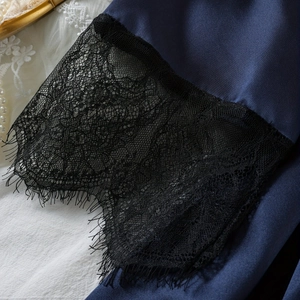 Dark blue satin robe and sleepwear set featuring intricate black lace trim and silk texture