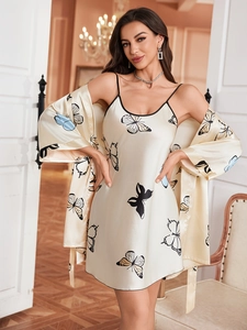 Detail of satin silk robe set featuring colorful butterfly prints and black trim piping