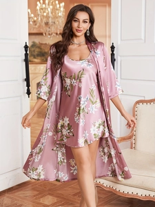 Detail of floral lotus pink satin pajama set with robe in an elegant indoor setting