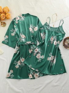Detail of green floral satin pajama set with silky texture and lace-up robe design