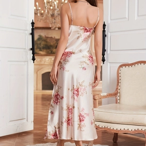 Floral satin slip dress with pink rose print and open back design in a home setting
