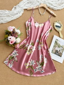 Detailed flat lay of pink lily print satin nightgown with elegant pearl accessories