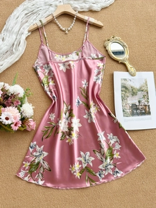 Detail of pink floral satin nightdress featuring delicate straps and silky texture
