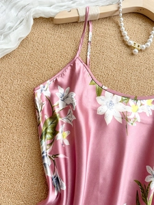 Detailed view of pink floral satin sleepwear with lily patterns and delicate straps