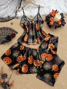 Detail of Halloween satin pajama set with orange pumpkin and spider web prints