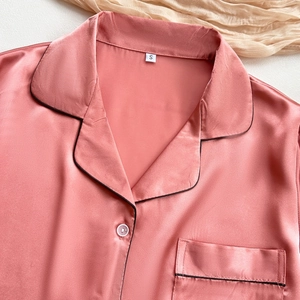 Pink satin silk pajamas set with short sleeves and black piping detail for women