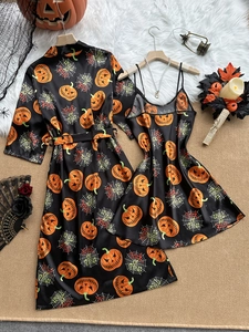 Detail of Halloween ice silk bathrobe with pumpkin and spider web prints in black satin