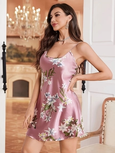 Detail of floral satin nightdress showing thin straps and silky texture in a luxury room
