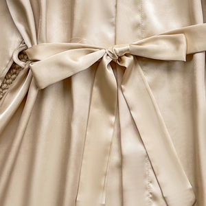 Champagne silk satin robe with elegant waist tie bow detail and smooth glossy finish