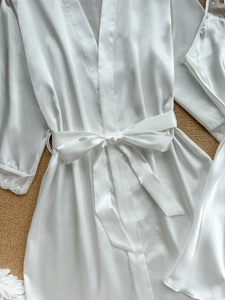 Weißer Satin-Bademantel mit Spitzenmanschetten und Bindegürtel in flacher Draufsicht