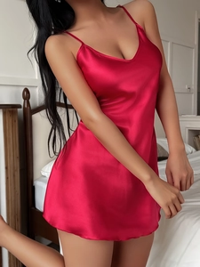 Detail of red satin nightgown showing the silky texture and sleek V-neck design