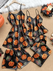 Detail of black satin Halloween sleepwear with pumpkin and spider web prints