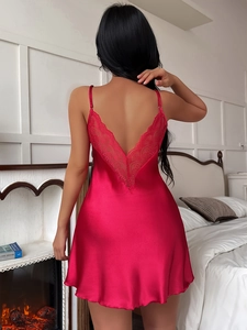 Close-up of the elegant deep V-back lace detailing on a red satin silk nightgown