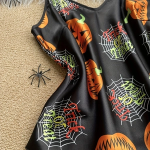 Three-piece Halloween satin pajama set with orange pumpkin and spider web prints