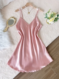 Nuisette en soie rose avec dentelle et décolleté en V sur fond de chambre élégant