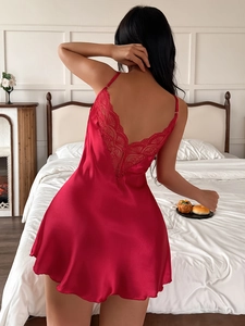 Close-up of red satin nightgown featuring lace-trimmed V-neck and delicate back straps