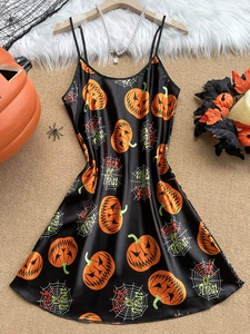 Detail of black satin Halloween sleepwear with pumpkin prints and spider web textures