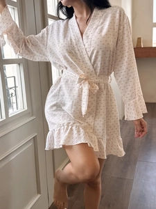 Detail view of cotton gauze robe featuring pink bow prints and delicate ruffled hemline