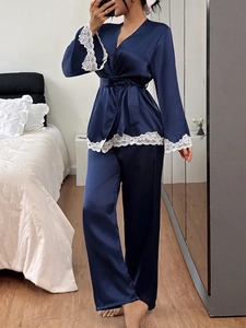 Deep blue satin pajama set with delicate white lace trim and adjustable waist tie