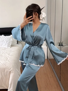 Detail of blue satin bathrobe with white lace trim and V-neck wrap design