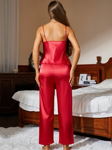 Detailed back view of red silk pajama set featuring delicate lace trim on the hem