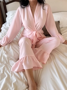 Pink seersucker pajama set featuring ruffle hems and a wrap-style kimono top detail