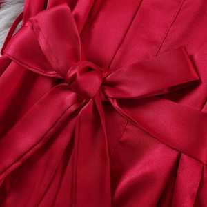 Elegant red satin robe with a large decorative bow and smooth glossy finish