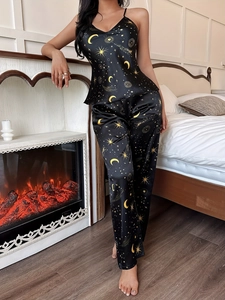 Detail of silk satin pajama set with celestial moon and star print on black fabric