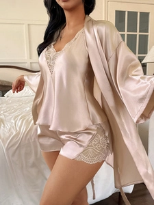 Close-up of champagne gold satin 3-piece sleepwear set with delicate white lace trim details