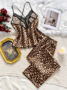 Detail showing leopard print satin camisole with delicate black lace trim and cross-back straps