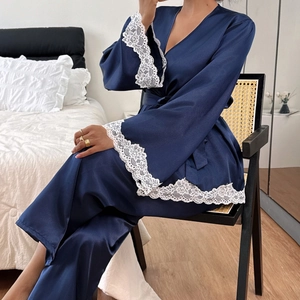 Women's dark blue satin pajama set featuring white floral lace trim on sleeves and hem