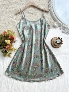 Detailed view of light green floral satin slip dress with delicate thin straps